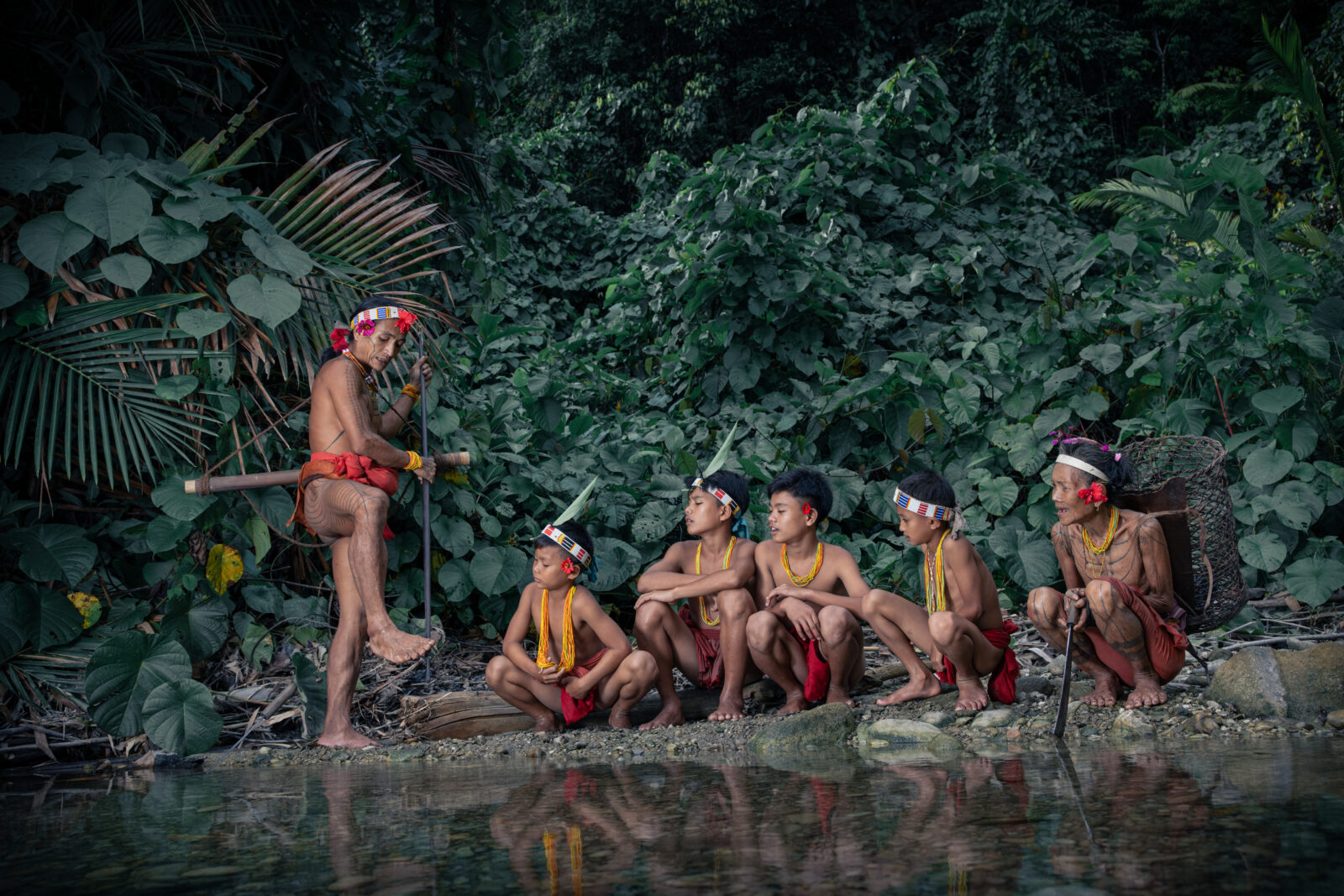 A Mentawai shaman on Siberut Island teaching children how to use bow and arrows