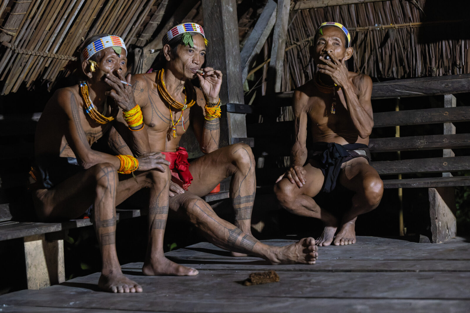 Mentawai Shamans smoking in traditional longhouse