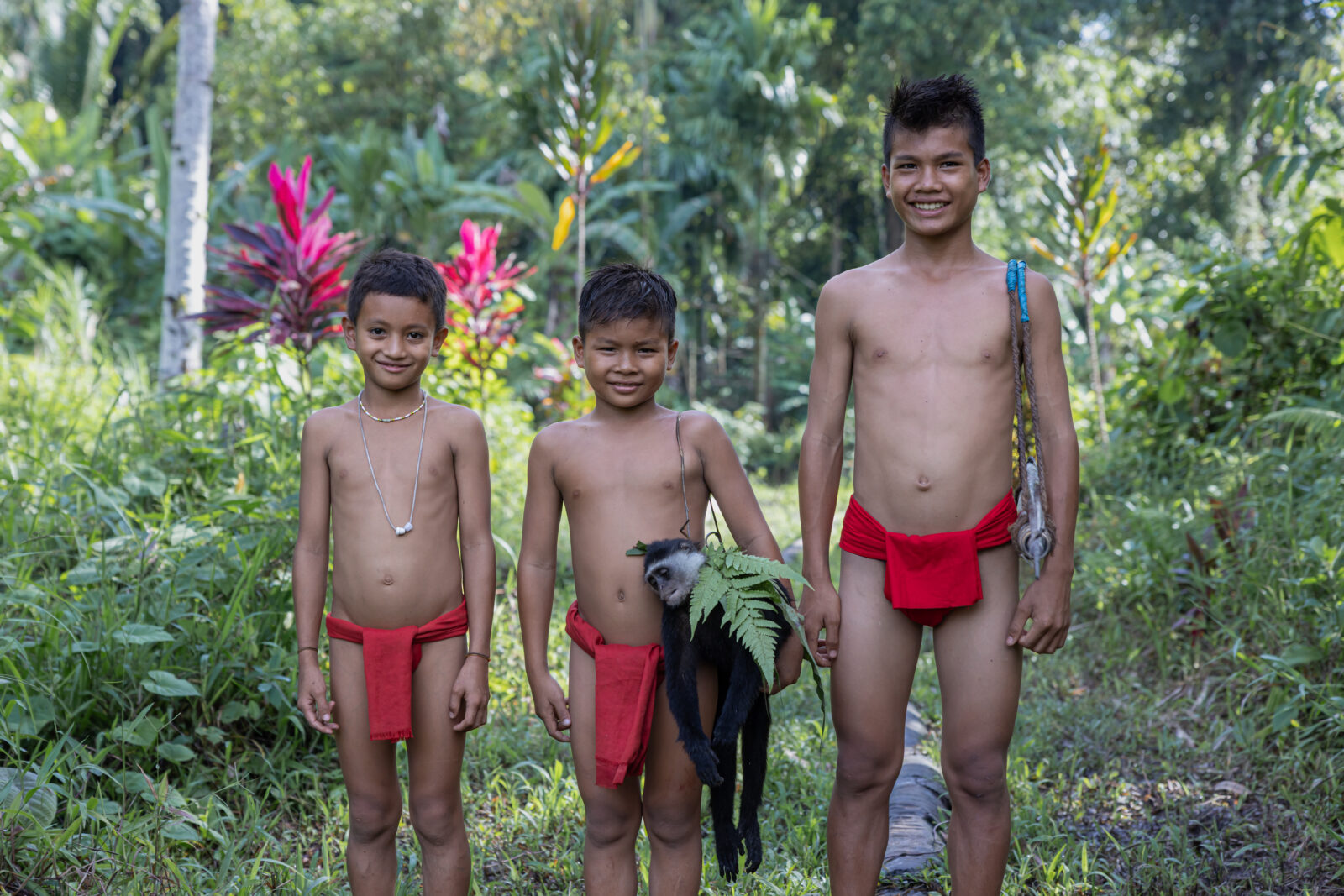Mentawai children with hunted joja langur monkey