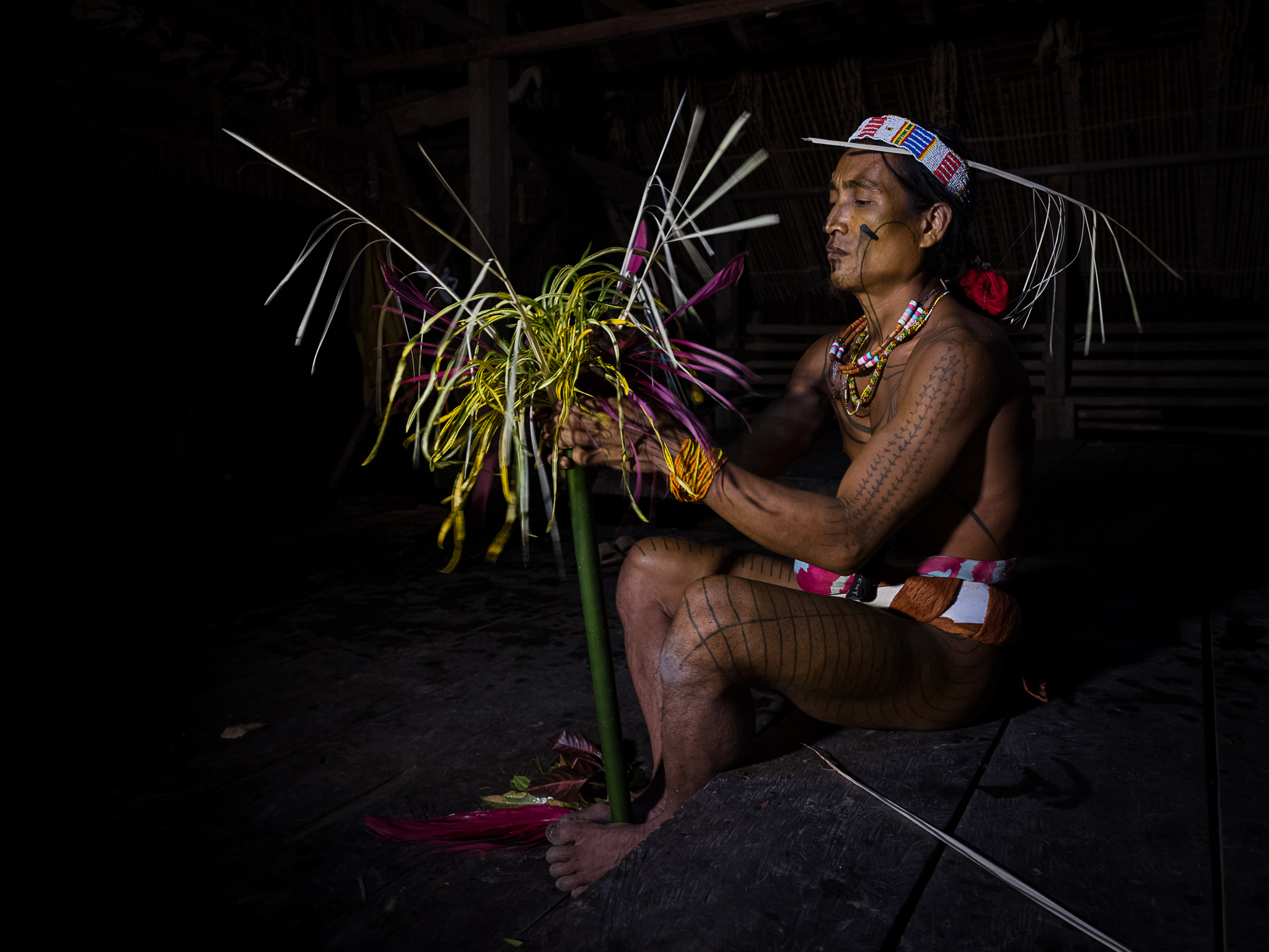 Indigenous person with ceremonial decorations.