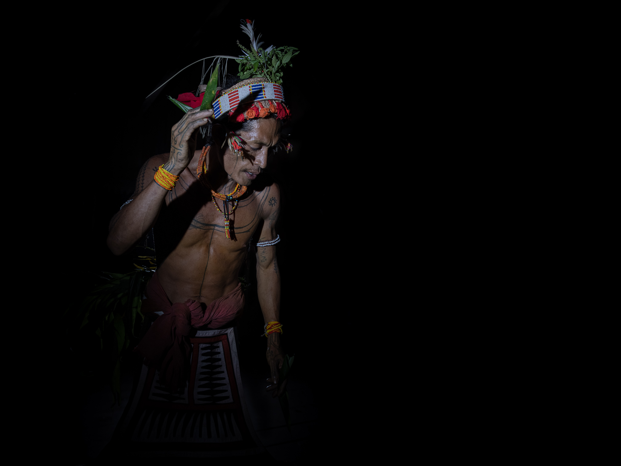 Indigenous person with traditional attire.