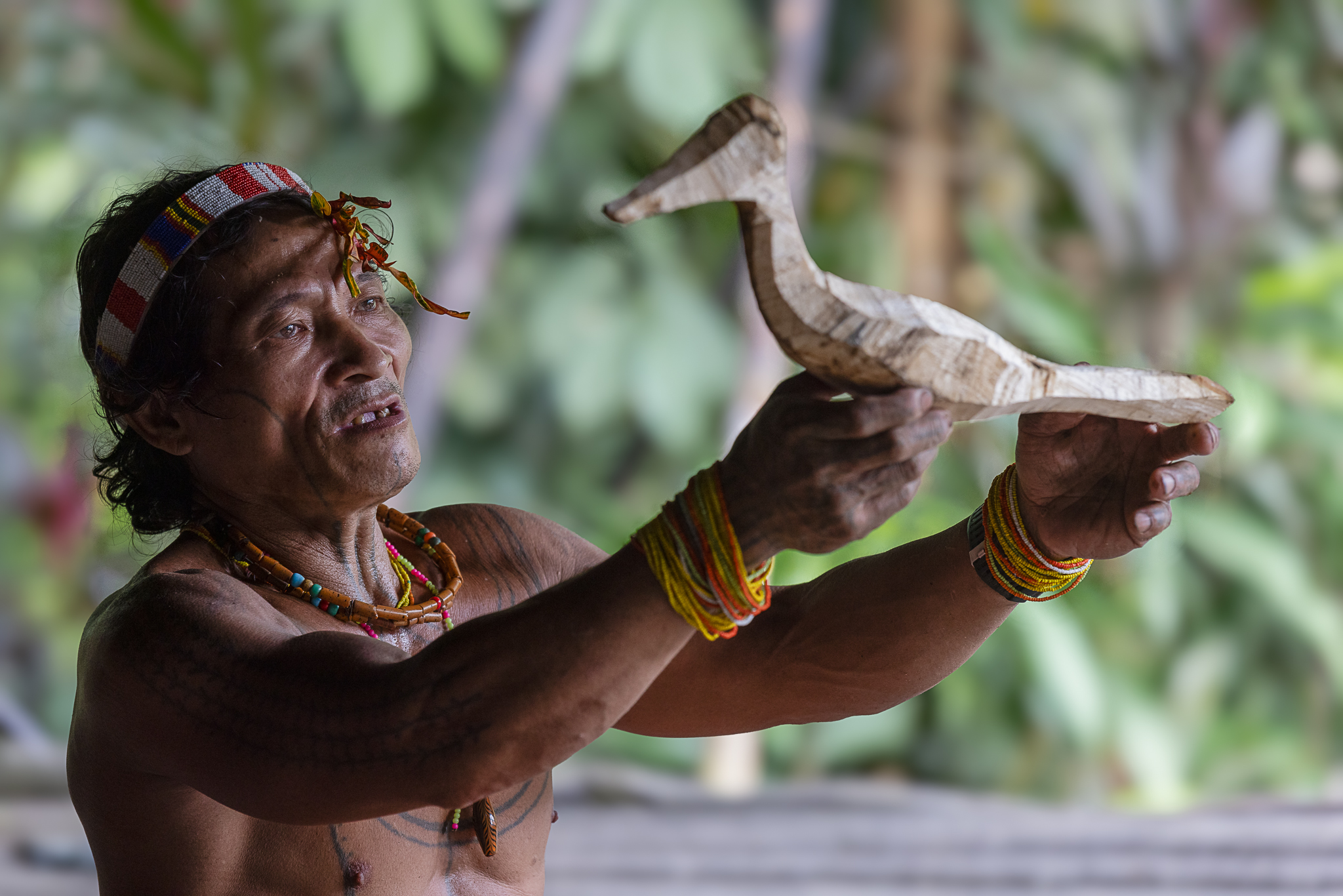 Mentawai shaman holding carved wooden bird