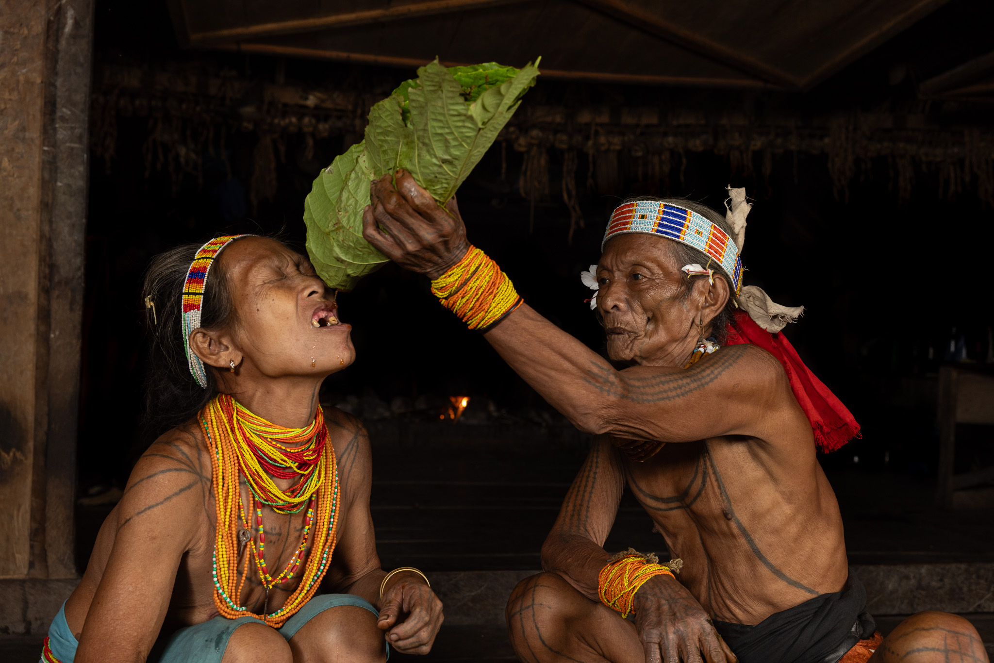 Mentawai shaman Siberut giving herbal medicine siberut island