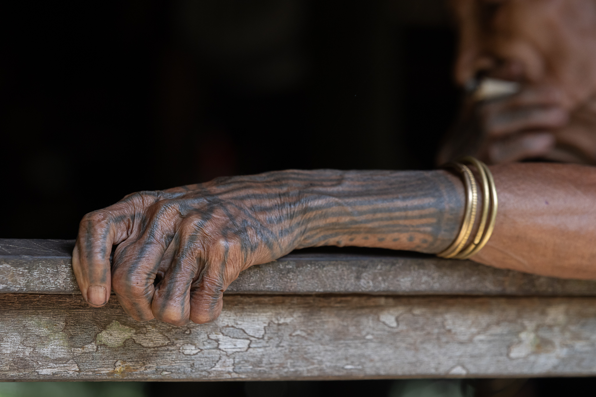 Elderly hand with intricate tattoos