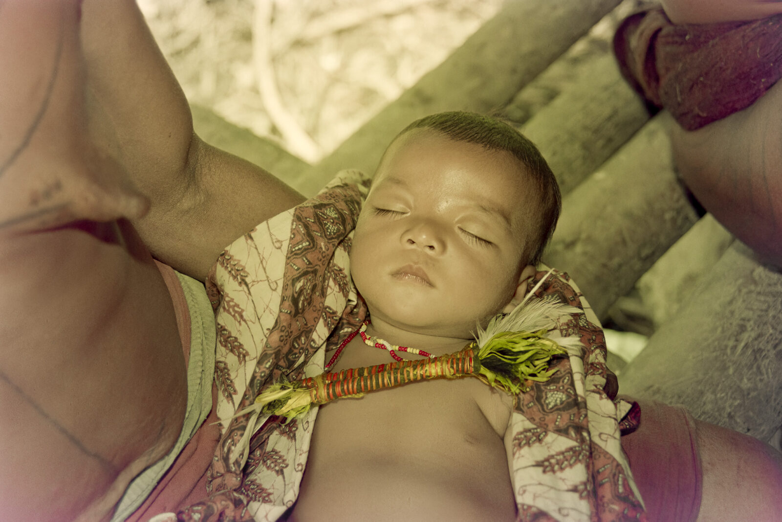 Mentawai mother and infant with gaut fetish necklace for spiritual protection