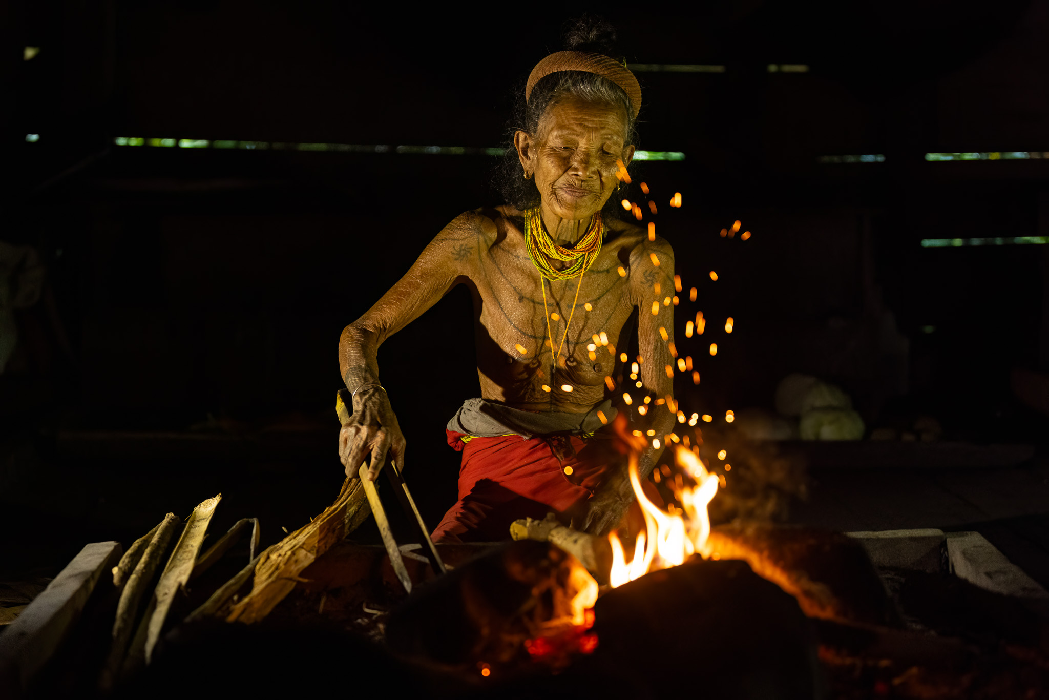 Mentawai woman making fire Siberut Indonesia
