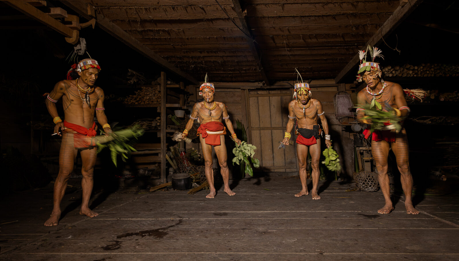 Mentawai shamans cleansing a traditional uma clan house during pasibitbit ritual on Siberut Island