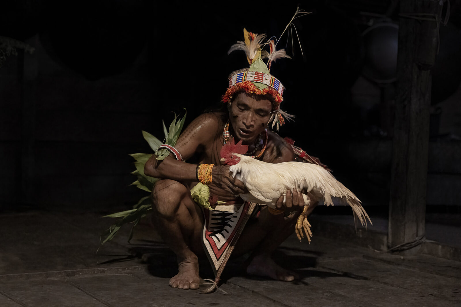 Mentawai shaman blessing a chicken on Siberut Island
