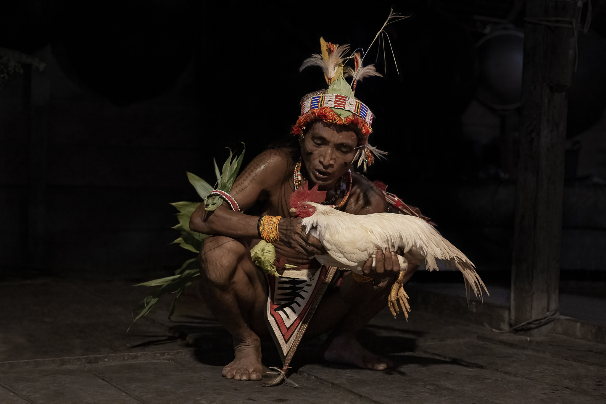 Mentawai shaman blessing a chicken on Siberut Island