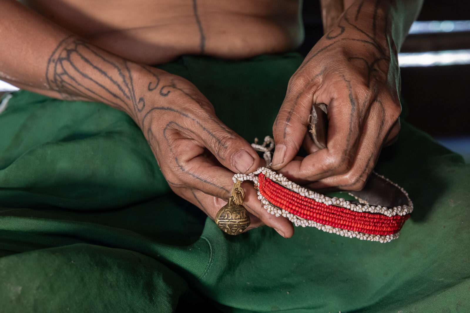 Mentawai woman fixing a shaman armband