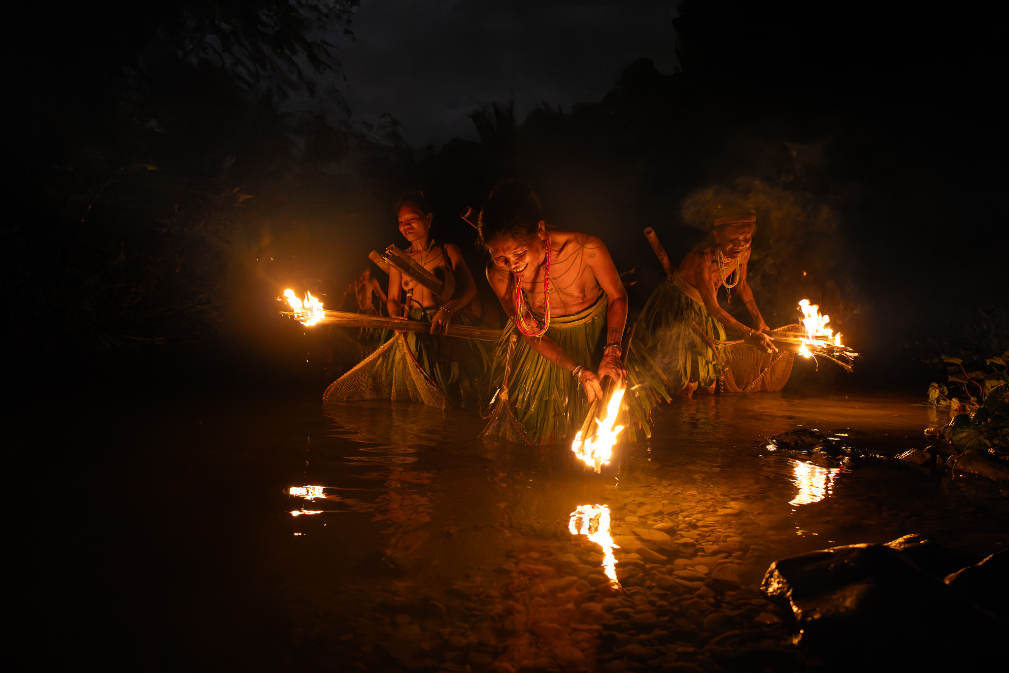 Mentawai women fishing torches night tour