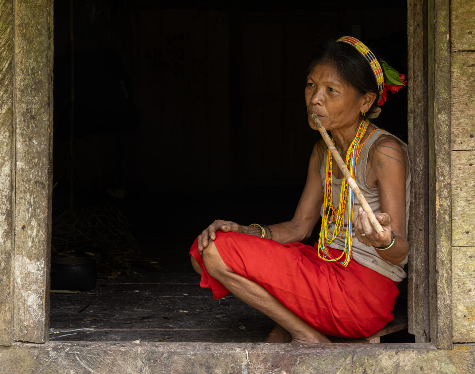 Mentawai woman playing bamboo flute on Siberut Island