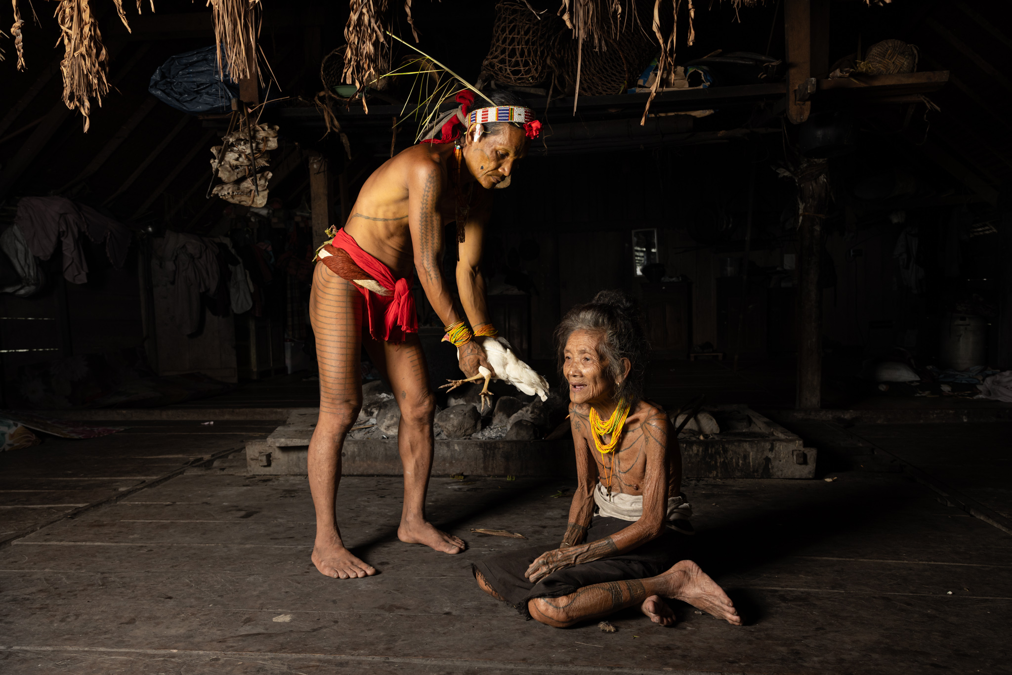 Mentawai shaman healing a woman with a chicken as mediator
